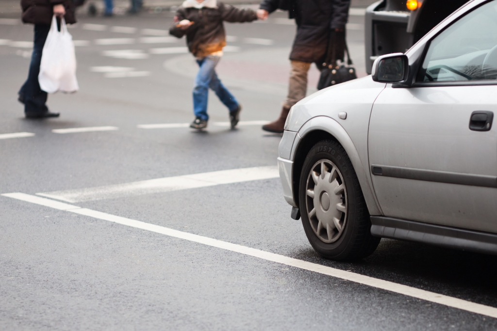 Pedestrian crossing the street along the highway.