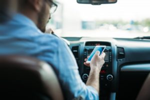 Man using phone while driving.