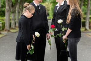 Sad daughter attending funeral of her late dad that had accident working offshore.