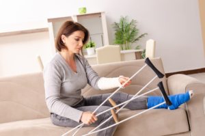 Injured woman holding her crutches.