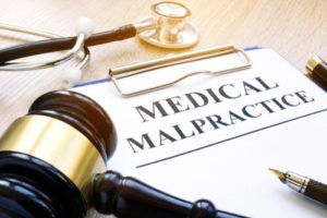 Paperwork and a gavel on the desk of a medical malpractice lawyer in Houston Texas.