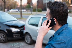 Driver calling the police to report car accident.