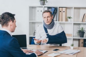 Injured worker submitting his worker injury claim form in Austin, TX.