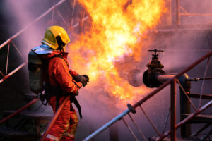 Fireman putting out fire from gas explosion.