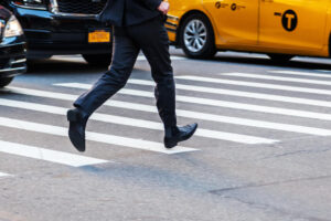 Pedestrian crossing a street in a hurry.