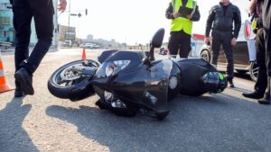 Motorcycle accident happening along the highway with police on site.