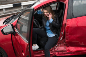 Lady driver injured at car collision calling for help.