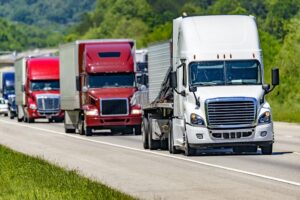 Trucks passing the interstate in convoy heading to their destination.